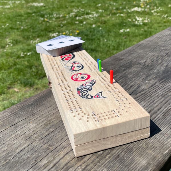 3-track cribbage board with pegs and playing cards